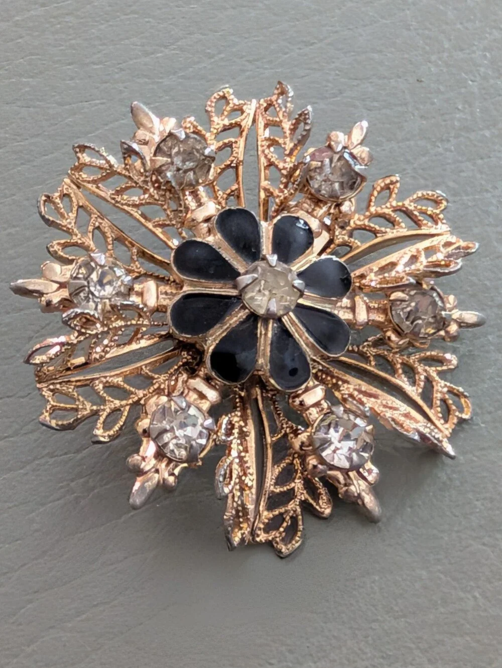 Gold-Tone Filigree Floral Starburst Brooch with Black Enamel and Clear Crystals